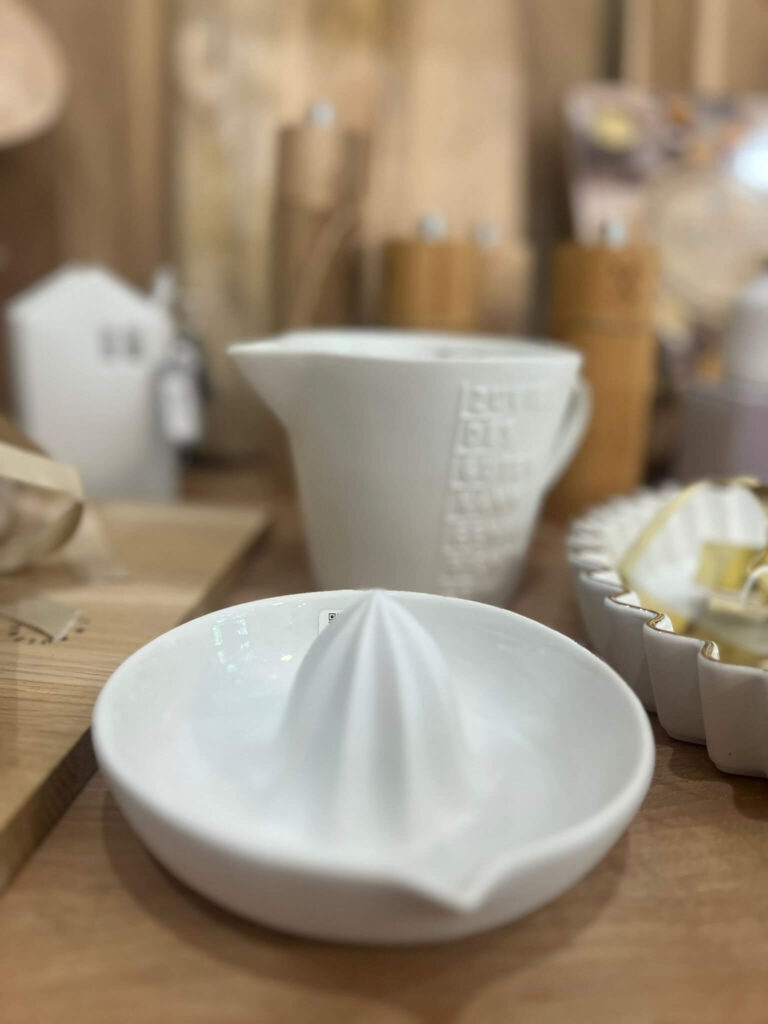 Weißer Keramik-Zitronenpresse auf Holztisch